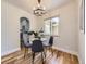 Cozy dining area with modern chandelier and view of the kitchen at 50 Yarrow St, Lakewood, CO 80226
