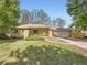 Charming single-story brick home with a well-manicured lawn and attached two car garage on a sunny day at 50 Yarrow St, Lakewood, CO 80226