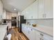 Modern kitchen with white cabinetry, stainless steel appliances, and hardwood flooring at 50 Yarrow St, Lakewood, CO 80226