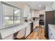 Well-lit kitchen boasts white cabinets, stainless steel appliances, and a windowed nook at 50 Yarrow St, Lakewood, CO 80226