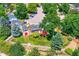 Overhead view of the house with a red deck, barn, and fenced yard at 6348 S Independence St, Littleton, CO 80123