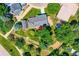 High-angle aerial view showing the house, a red deck, and lush green surroundings at 6348 S Independence St, Littleton, CO 80123