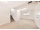 Spacious basement featuring carpeted floors, stairs, a window, and ample room for storage at 6348 S Independence St, Littleton, CO 80123