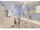 Updated bathroom featuring modern vanity with stone countertop, new fixtures, and blue accent walls at 6348 S Independence St, Littleton, CO 80123