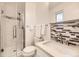 Updated bathroom featuring a glass enclosed shower, tiled accents, and modern fixtures at 6348 S Independence St, Littleton, CO 80123