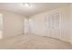 Bedroom featuring plush carpet and a closet with white bi-fold doors at 6348 S Independence St, Littleton, CO 80123