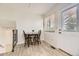 Cozy dining nook with a wooden table and seating for four near the back door and window at 6348 S Independence St, Littleton, CO 80123