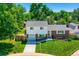 Charming two-story home featuring a brick facade, well-maintained lawn, and attached garage at 6348 S Independence St, Littleton, CO 80123