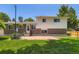 Exterior view of the home showcasing a brick and vinyl facade, complimented by a green lawn at 6348 S Independence St, Littleton, CO 80123