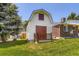 A detached garage sits aside green lawn, offering parking and extra storage at 6348 S Independence St, Littleton, CO 80123