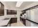 Modern kitchen showcasing stainless steel appliances, sleek countertops, and dark wood cabinetry at 6348 S Independence St, Littleton, CO 80123