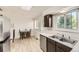 Bright kitchen featuring stainless steel appliances, double basin sink, and a cozy dining nook at 6348 S Independence St, Littleton, CO 80123