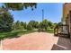 Brick patio offers serene views of the lush green lawn and mature trees, perfect for outdoor relaxation at 6348 S Independence St, Littleton, CO 80123