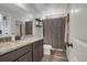 Bathroom with dark wood vanity and shower with patterned curtain at 4391 S Nepal St, Centennial, CO 80015