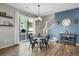 Bright dining area with stylish table and chairs, sliding glass door, and access to outdoor space at 4391 S Nepal St, Centennial, CO 80015