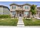 Charming two-story home featuring stone accents, a welcoming front porch, and a well-manicured lawn at 4391 S Nepal St, Centennial, CO 80015