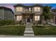 Charming two-story home featuring stone accents, a welcoming front porch, and a well-manicured lawn at 4391 S Nepal St, Centennial, CO 80015
