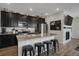 Modern kitchen with granite countertops, stainless steel appliances, and a spacious island with seating at 4391 S Nepal St, Centennial, CO 80015