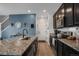 Modern kitchen featuring granite countertops, stainless steel appliances, and a convenient island with a sink at 4391 S Nepal St, Centennial, CO 80015