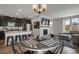 Open-concept kitchen and dining area with modern appliances, granite countertops, and stylish bar stools at 4391 S Nepal St, Centennial, CO 80015