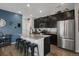 Modern kitchen with granite countertops, stainless steel appliances, and a spacious island with seating at 4391 S Nepal St, Centennial, CO 80015