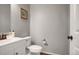 This half bathroom features a white vanity and toilet with neutral paint color at 4391 S Nepal St, Centennial, CO 80015