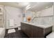 Modern bathroom with a double vanity, granite countertops, and a glass-enclosed shower at 410 Acoma St # 314, Denver, CO 80204