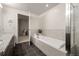 A well-lit bathroom that features a soaking tub, separate shower and modern tile at 410 Acoma St # 314, Denver, CO 80204