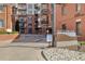 Exterior of brick condominium building with 'Watermark' signage and landscaped entrance at 410 Acoma St # 314, Denver, CO 80204