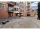 Brick condominium building showcasing multiple balconies, windows, and covered parking at 410 Acoma St # 314, Denver, CO 80204
