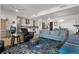An open concept living area featuring a leather chair, light blue sofa and a modern kitchen at 410 Acoma St # 314, Denver, CO 80204
