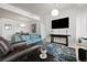 Bright living room with light wood floors, light blue sofa, and floral patterned rug at 410 Acoma St # 314, Denver, CO 80204