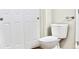 Clean bathroom featuring a toilet and a white sliding door at 8726 S Kline St # A208, Littleton, CO 80127