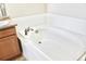 A white bathtub with white tile surround with chrome faucet and fixtures at 8726 S Kline St # A208, Littleton, CO 80127