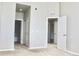 Light and airy bedroom with neutral walls and carpet, highlighting access to other rooms at 8726 S Kline St # A208, Littleton, CO 80127