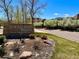 Chatfield Bluffs community sign surrounded by trees, landscaping, and a glimpse of the neighborhood at 8726 S Kline St # A208, Littleton, CO 80127