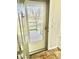 Front door view opening to an outdoor porch or balcony with exposed brick flooring inside at 8726 S Kline St # A208, Littleton, CO 80127