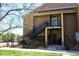 Apartment exterior with stairs leading to upper units, visible unit numbers, and well-maintained lawn at 8726 S Kline St # A208, Littleton, CO 80127