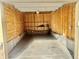 Empty garage with plywood walls and concrete floor at 8726 S Kline St # A208, Littleton, CO 80127