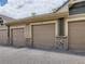 Row of garages with stone accents and gravel driveway at 8726 S Kline St # A208, Littleton, CO 80127