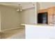 Bright open-concept kitchen with black appliances and island extending into the carpeted living area at 8726 S Kline St # A208, Littleton, CO 80127
