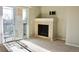Bright living room with fireplace, sliding glass door to balcony, and neutral carpeting at 8726 S Kline St # A208, Littleton, CO 80127