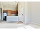 Open concept living area with bright lighting, a modern kitchen, and neutral paint scheme at 8726 S Kline St # A208, Littleton, CO 80127