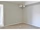 Neutral colored living room featuring modern chandelier and beige carpet at 8726 S Kline St # A208, Littleton, CO 80127