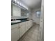 Bathroom with tile flooring features double sinks and a spacious vanity with plenty of storage at 894 S Krameria St, Denver, CO 80224