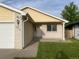 Inviting entryway with a white front door and well-manicured lawn at 894 S Krameria St, Denver, CO 80224