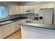 Functional kitchen featuring a breakfast bar and essential appliances at 894 S Krameria St, Denver, CO 80224