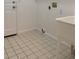 The laundry room offers tile flooring, a utility sink, and plenty of space for tasks and storage at 894 S Krameria St, Denver, CO 80224