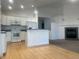 Open-concept kitchen flowing into the living room with a cozy fireplace and hardwood floors at 894 S Krameria St, Denver, CO 80224