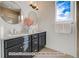 Elegant bathroom with double vanity, dark cabinetry, and large mirrors at 2732 W 68Th Ave, Denver, CO 80221
